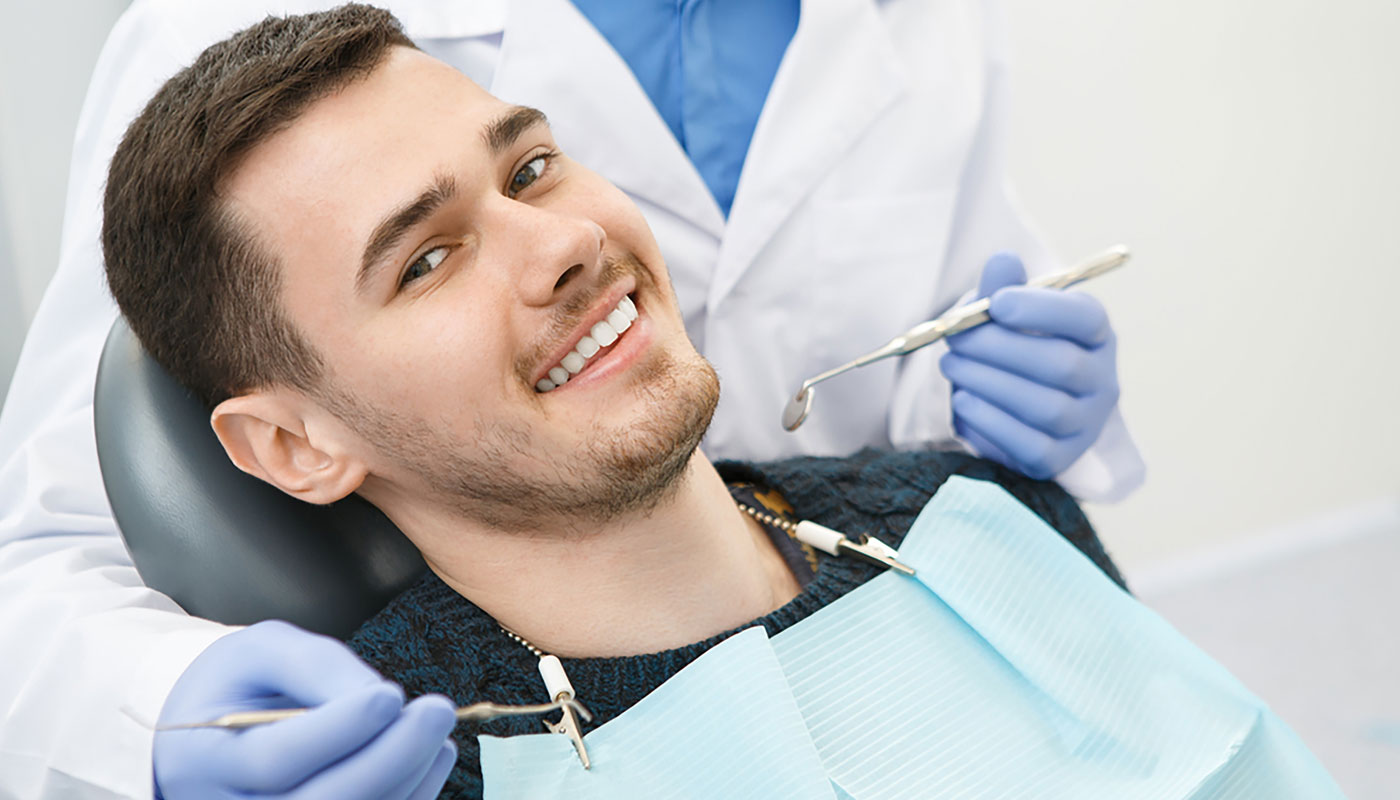 Patient smiling after receiving a dental crown restoration