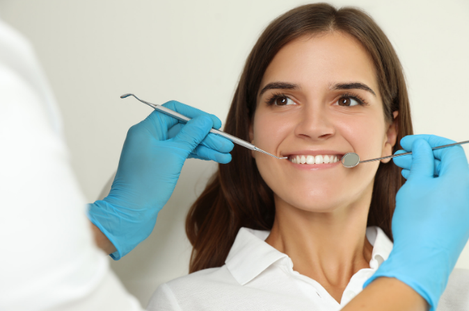 Smile showing replaced missing teeth with fixed dental bridges
